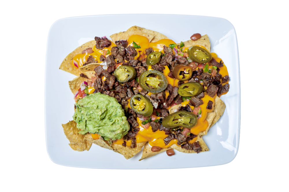 Nachos with steak, jalapeños, cheese, and guacamole